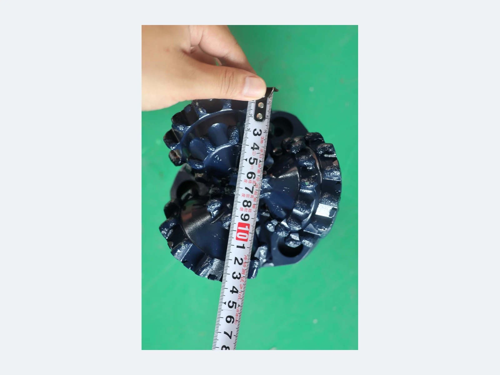 DRILLNOVA 5.5 inch tricone bit diameter inspection with measuring tape