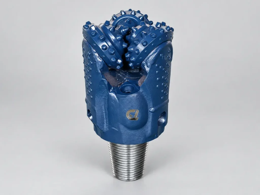 Image alt text: Blue TCI tricone drill bit with three roller cones and threaded pin connection
